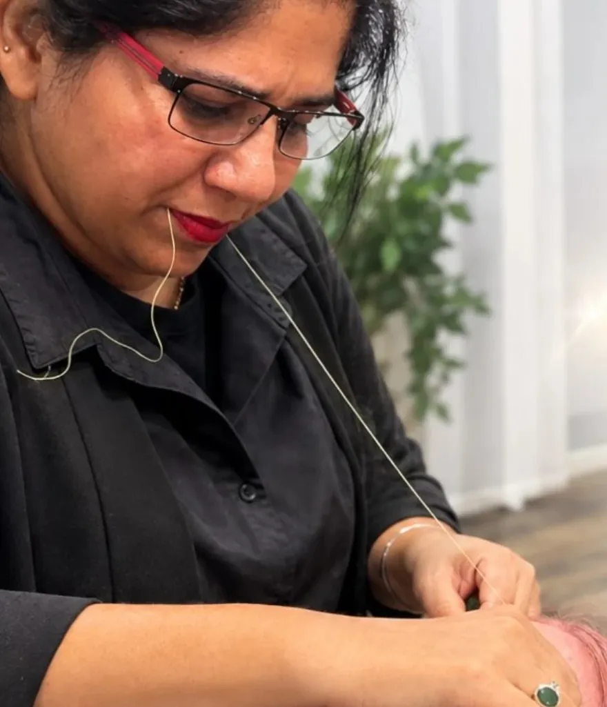Our owner threading a client&rsquo;s eyebrows, upstairs in the salon